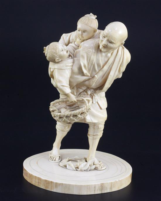 A Japanese ivory group of a man carrying two boys, Meiji period, height 16cm, age cracks and losses